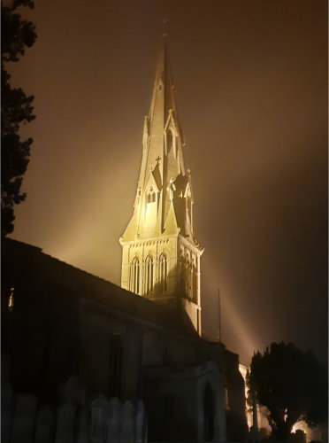 St Mary's Spire with lighting on a misty night
